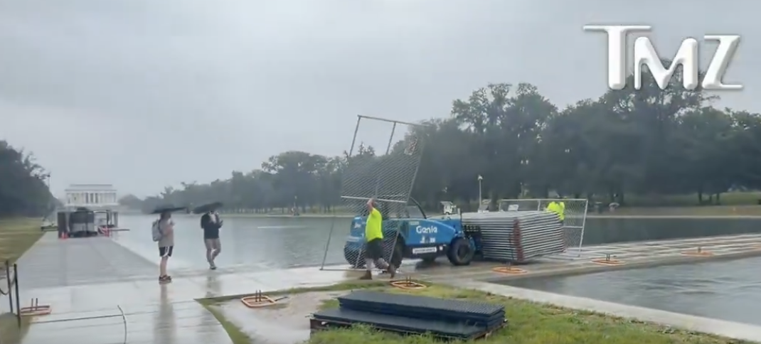 Workers Seen Putting Up Metal Fencing Near Reflecting Pool